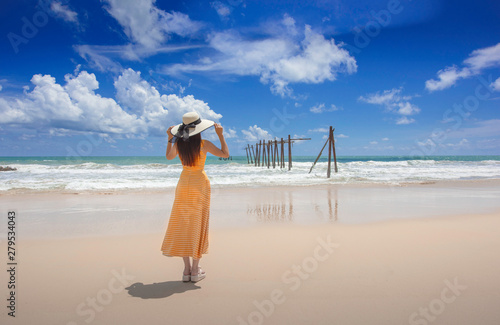 Asian woman standing by the beach near Old bridge Khao pilai natai beach Phangnga ,Thailand. photo