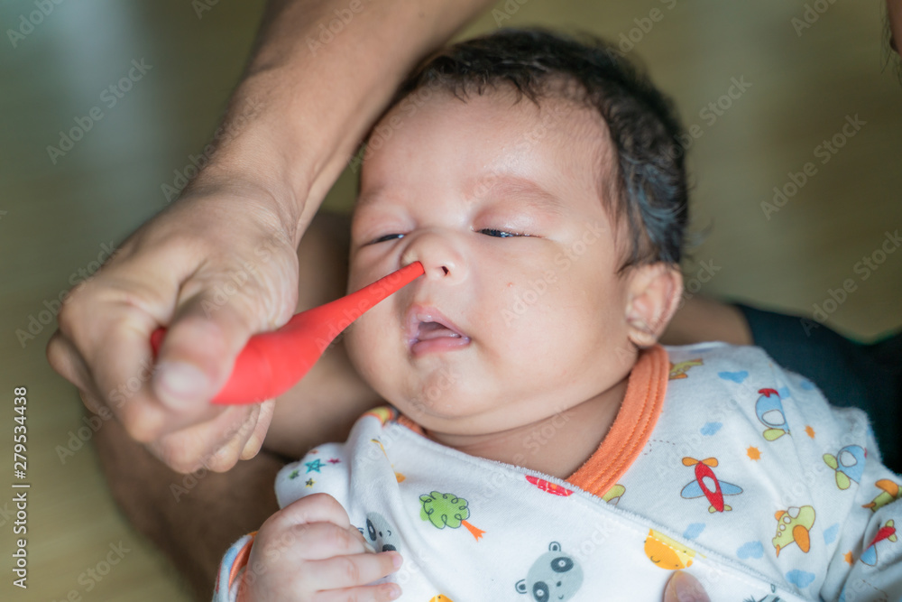 Father suck the snot from baby boy Father suck the snot from baby boy