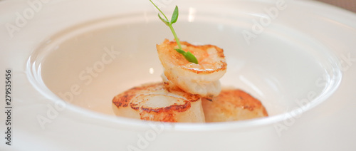 Grilled shrimp seared scallops in white bowl plate