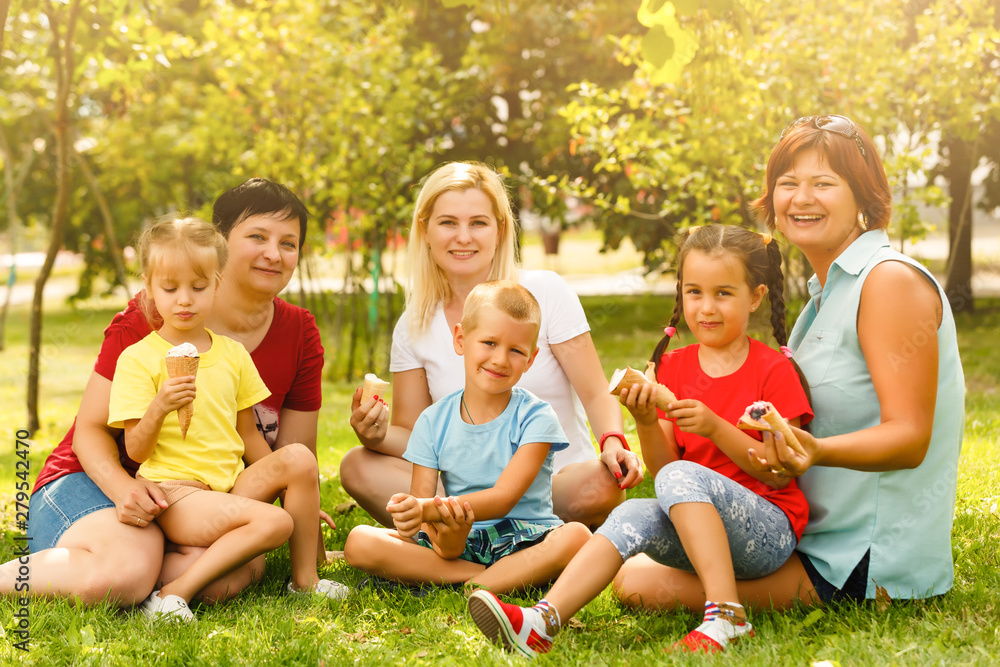 Fototapeta premium Happy mothers and children in the park