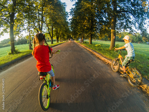 Fototapeta Naklejka Na Ścianę i Meble -  children on bicycles in the park near school.