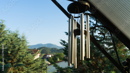 Valokuva Garden decoration, wind chimes hanging under the roof of the balcony of a house