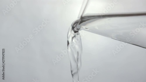 glass of water being poured. empty out glass of water.