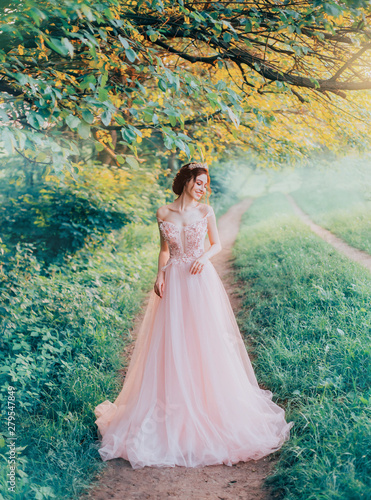 tender innocent girl confusedly looks away, forest fairy walks over her possession, attractive young bride with dark hair in long pink dress to floor, creative colors, blue green grass and trees