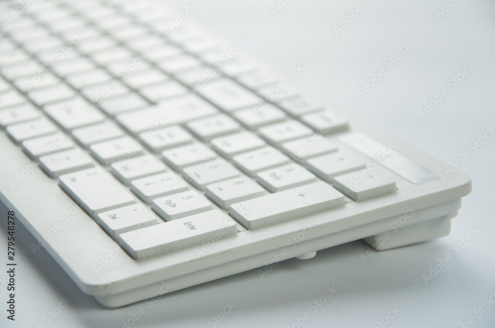 white computer keyboard lies on a table on a white background white computer keyboard lies on a table on a white background