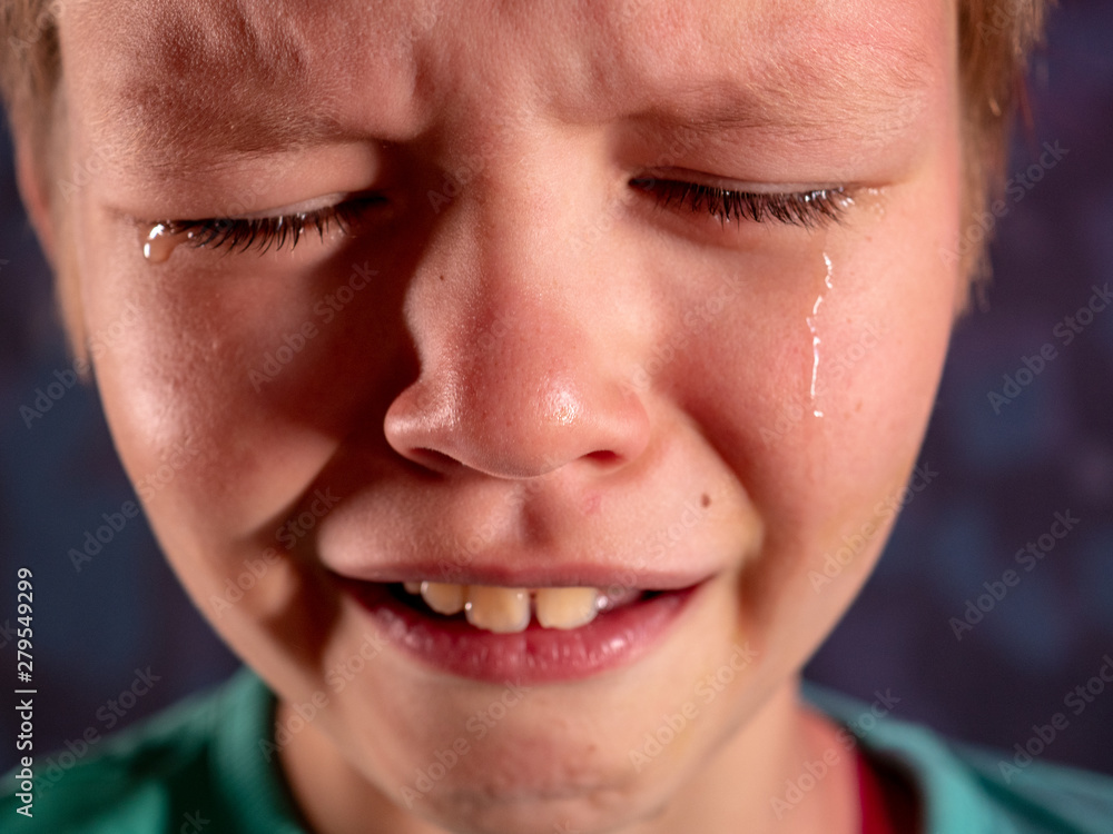 Face of crying boy close up. Eyes, eyelashes, eyebrows, lips, teeth and tears. Emotions and grimaces of upset child Face of crying boy close up. Eyes, eyelashes, eyebrows, lips, teeth and tears. Emotions and grimaces of upset child