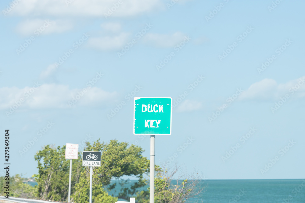 Duck Key, USA Overseas highway, freeway road, street with sign for Florida island city, ocean, sea water, bike lane signs