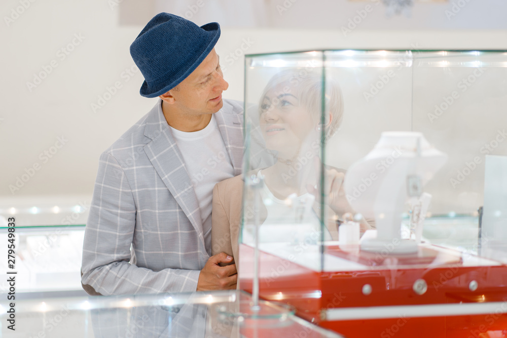 Male and female consumers in jewelry store Male and female consumers in jewelry store