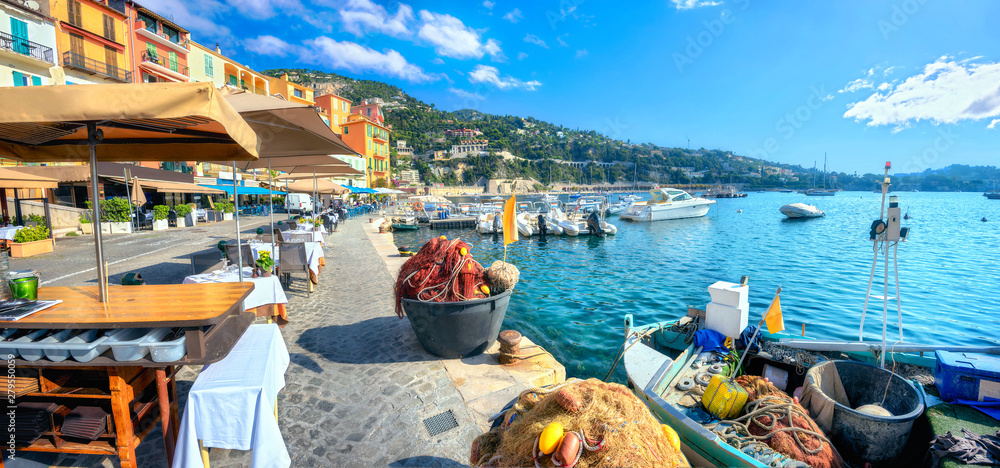 Street scene with cafe and fishing boat in resort town Villefranche-sur-Mer. Cote d'Azur, France - obrazy, fototapety, plakaty 