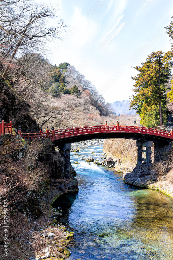 View on mountains and famous red bridge landmark in Nikko, Tochigi prefecture in Japan with blue water in early spring View on mountains and famous red bridge landmark in Nikko, Tochigi prefecture in Japan with blue water in early spring