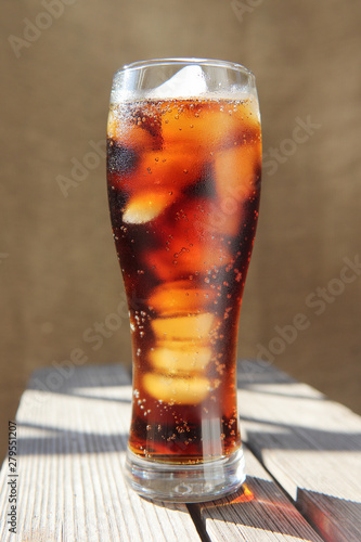 A glass covered with dew drops with a cold drink.