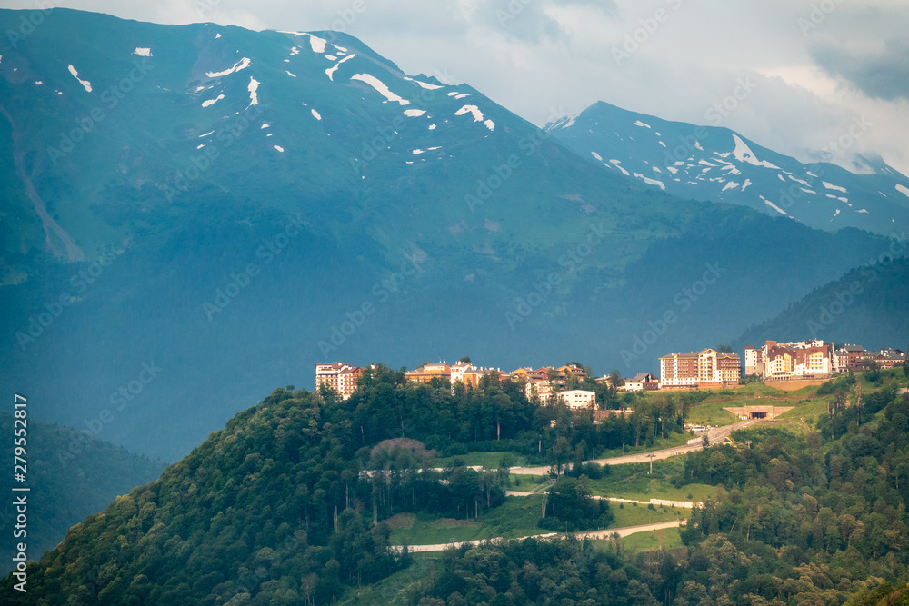 Hotel in the mountains among the green forest. Krasnaya Polyana, Sochi, Russia