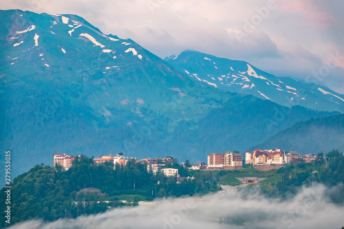 Hotel in the mountains among the green forest. Fog in the mountains. Krasnaya Polyana, Sochi, Russia