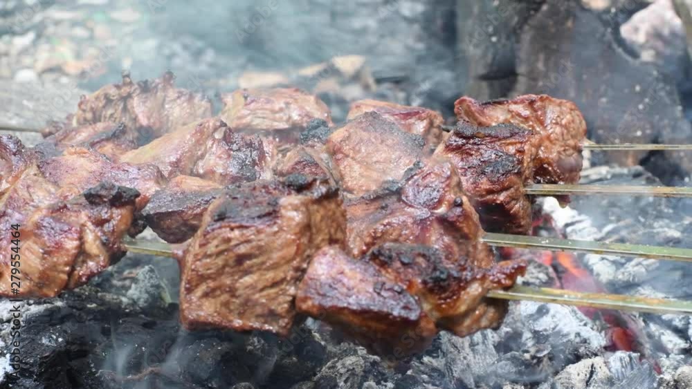 Grilled shish kebab on skewer. Roasted beef meat cooked at barbecue. Traditional eastern dish shashlik. Grilled shish kebab on skewer. Roasted beef meat cooked at barbecue. Traditional eastern dish shashlik.