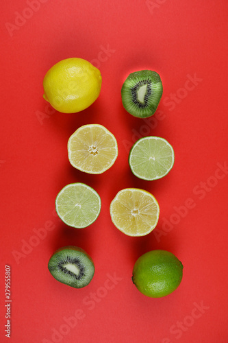 citrus and kiwi on a red background upside