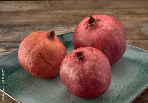 Delicious juicy red pomegranate.On wooden background