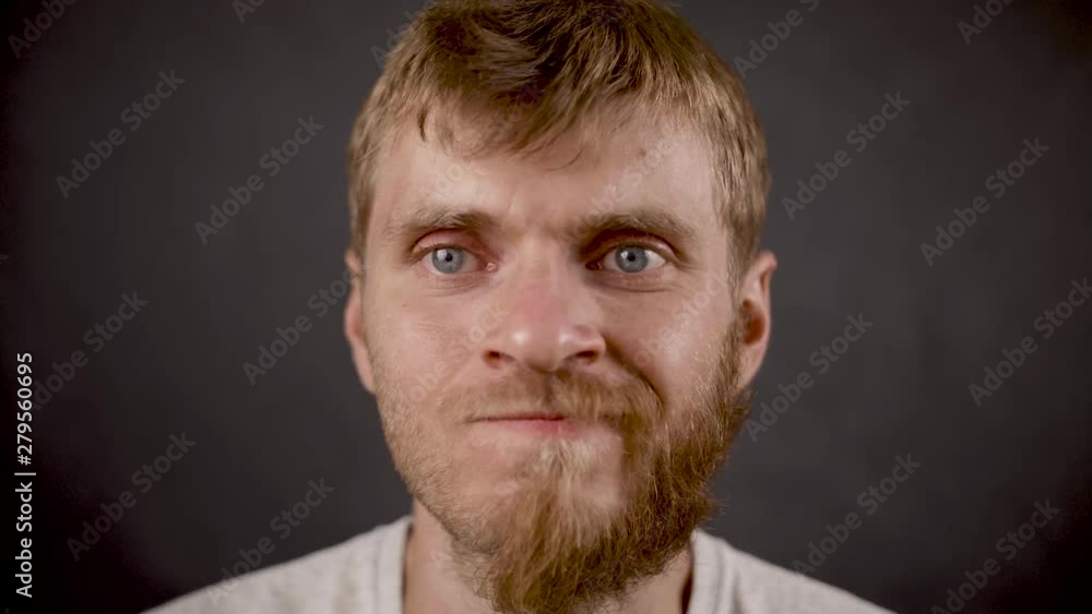Handsome bearded hipster male mistruts in the black studio Handsome bearded hipster male mistruts in the black studio
