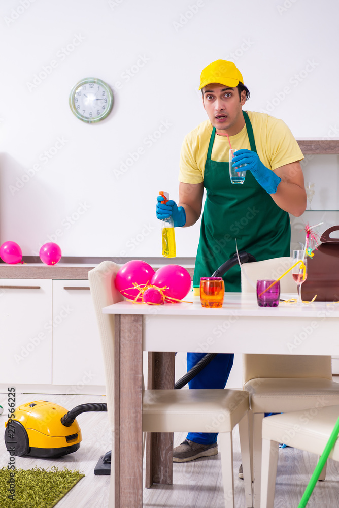 Young male contractor doing housework after party Young male contractor doing housework after party