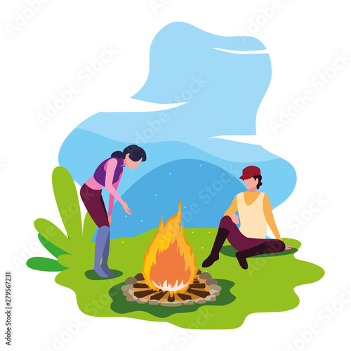 man and woman with bonfire camping hiking landscape