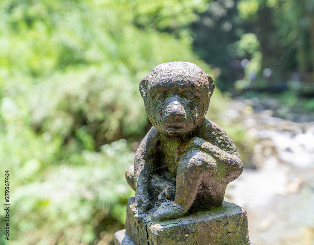 Monkey statue along the mountain road of Emei Mountain, China