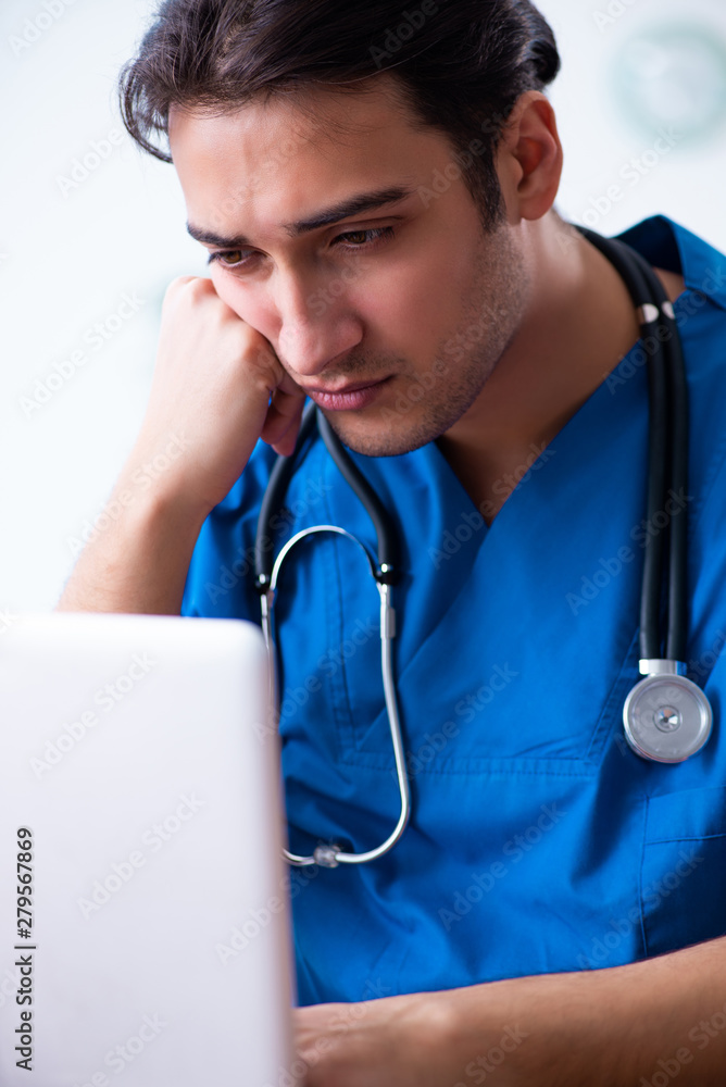 Young male doctor in telehealth concept Young male doctor in telehealth concept