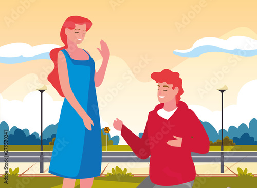 man kneeling with woman holding hand