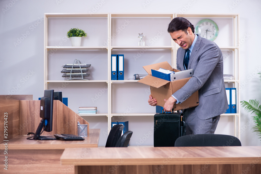 Young male employee being fired from his work Young male employee being fired from his work