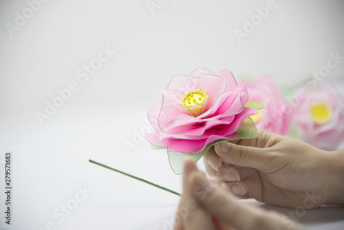 Woman making beautiful nylon flower - people with DIY handmade flower concept photo