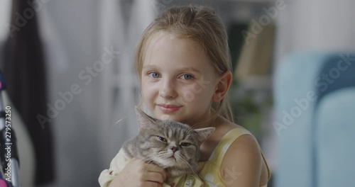 Girl holding a cat photo