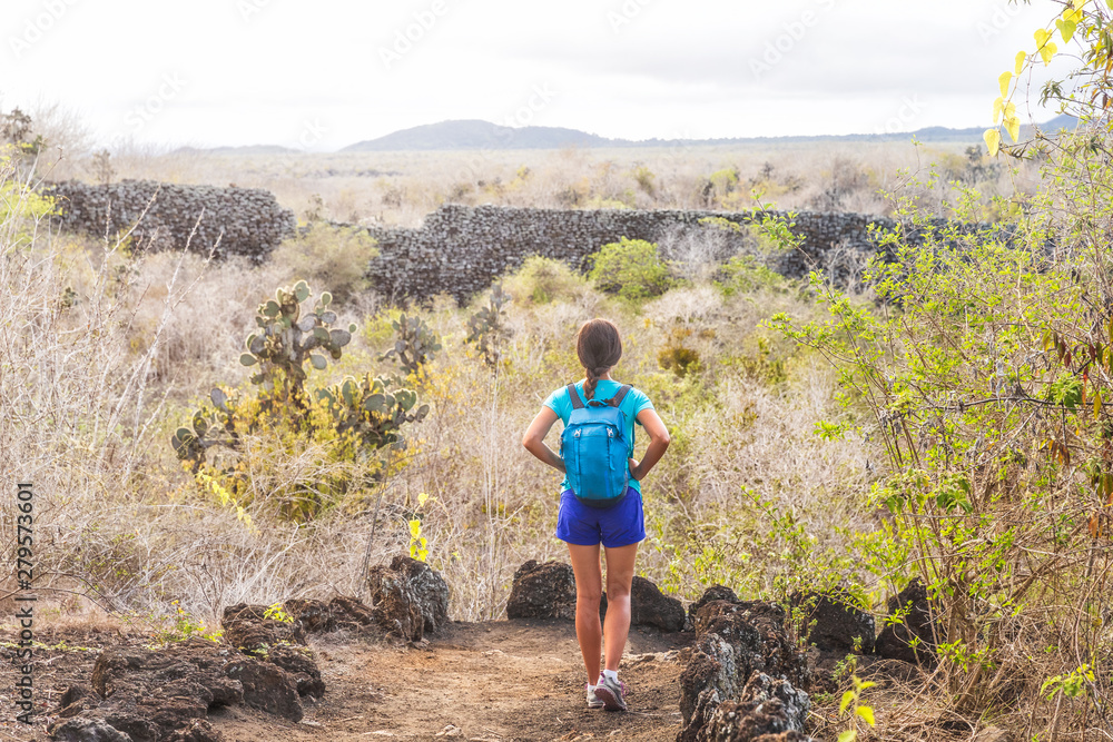 Fototapeta premium Galapagos Isabela island travel tourist at El Muro de las Lagrimas the wall of tears in Puerto Villamil, woman walking at historical ecuadorian site. Ecuador tourism attraction. Ecotourism.