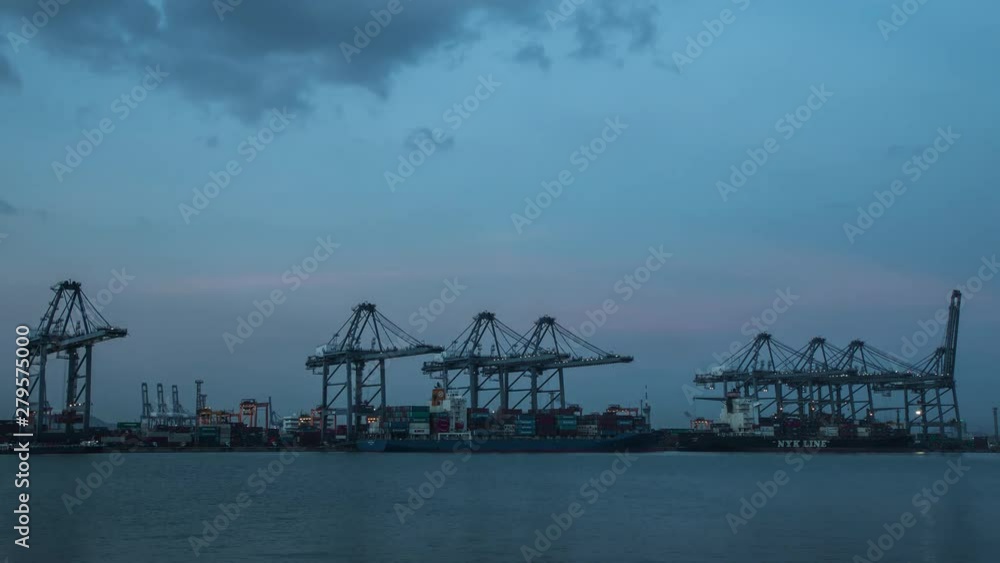 Container Cargo freight ship with working crane loading bridge in shipyard at dusk, 4K Day to Night Time lapse Container Cargo freight ship with working crane loading bridge in shipyard at dusk, 4K Day to Night Time lapse