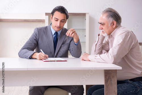 Male real estate agent and male client in the apartment