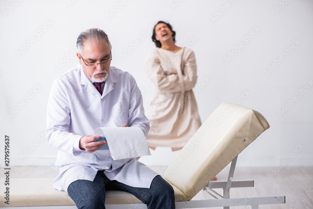 Aged male doctor psychiatrist examining young patient Aged male doctor psychiatrist examining young patient
