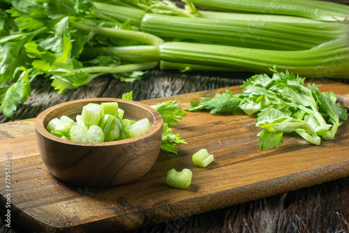 Sliced fresh celery or Celery stalk on cutting wooden board