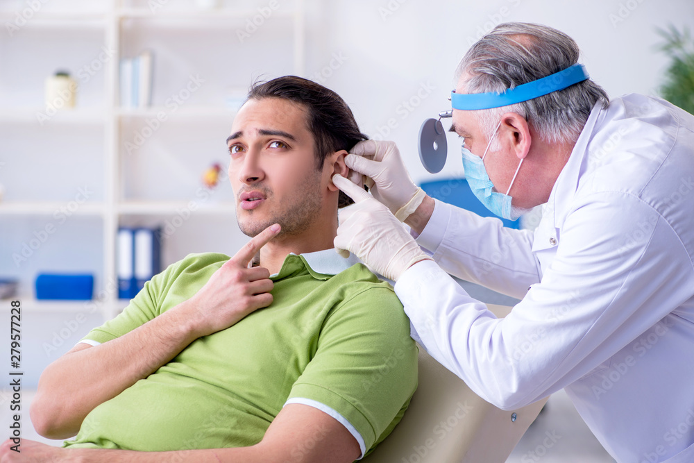 Male patient visiting doctor otolaryngologist Male patient visiting doctor otolaryngologist