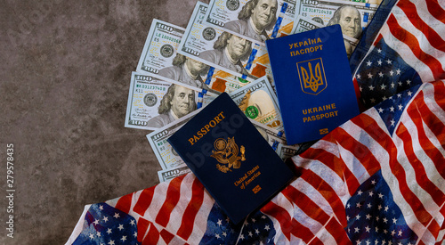 Ukrainian passport and American Passport in the US flag with bills of one hundred dollars