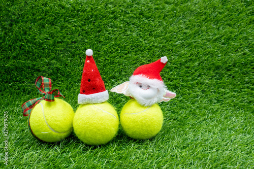 Merry Christmas to Tennis player with Christmas decoration on green grass background