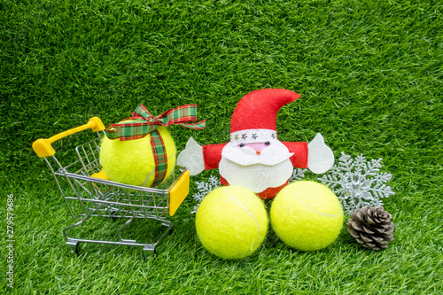 Merry Christmas to Tennis player with Christmas decoration on green grass background