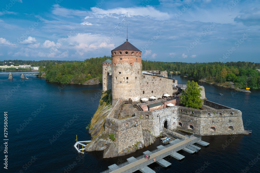View of the ancient fortress of Olavinlinna on a sunny July day (shooting from a quadrocopter). Savonlinna, Finland