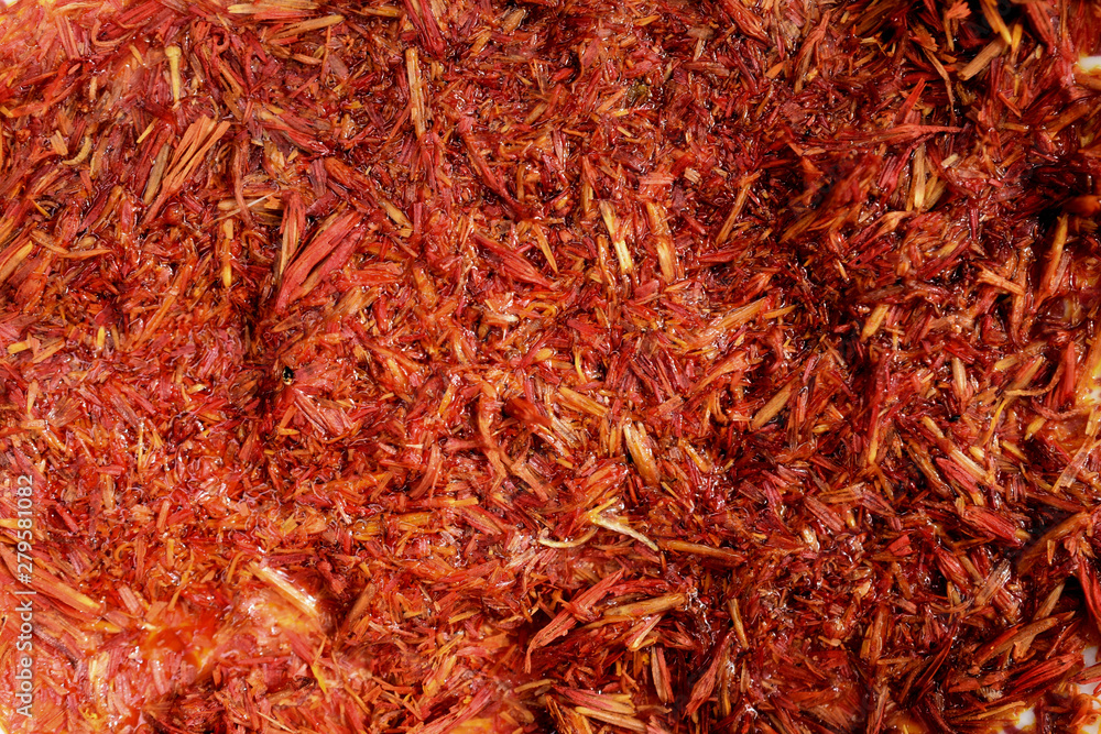 Fototapeta premium saffran in the form of dried petals, macro, spices, rice, blurred background