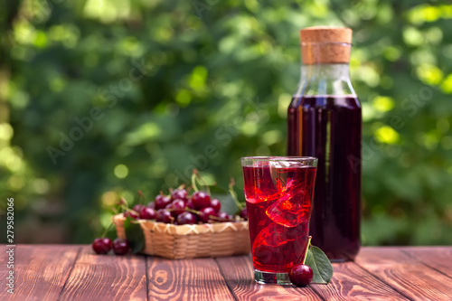 cherry juice or cocktail with ice in glass