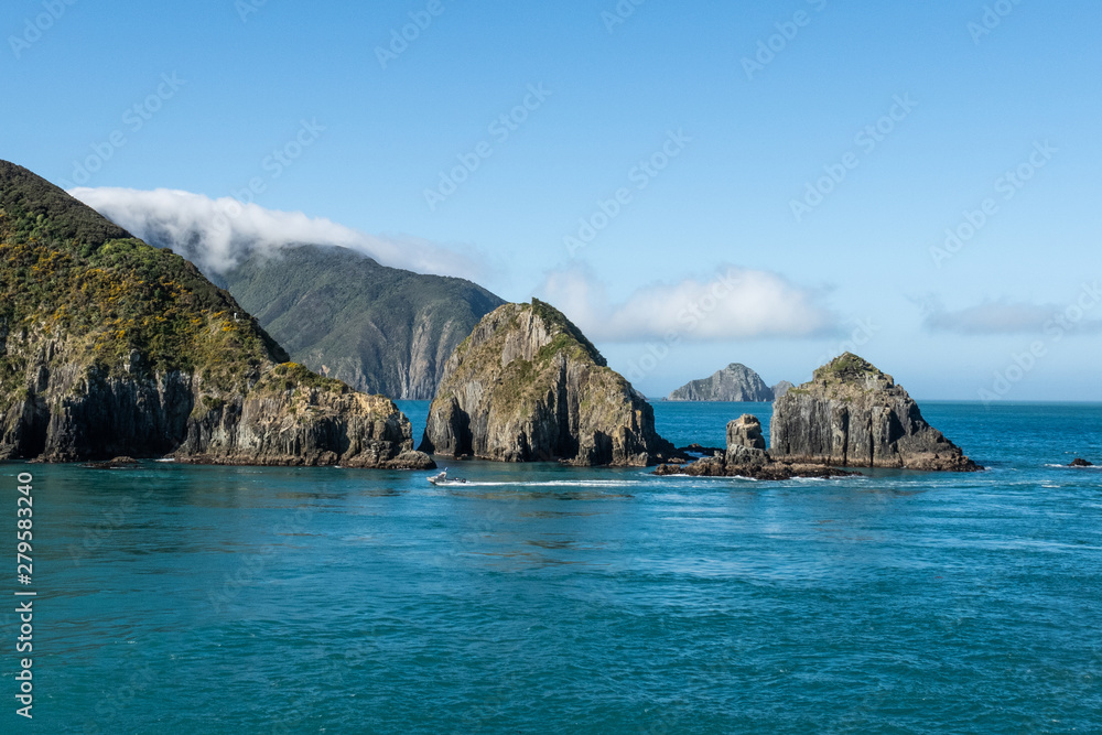 Beautifil rugged costal scenery sailing across the ocean in New Zealand