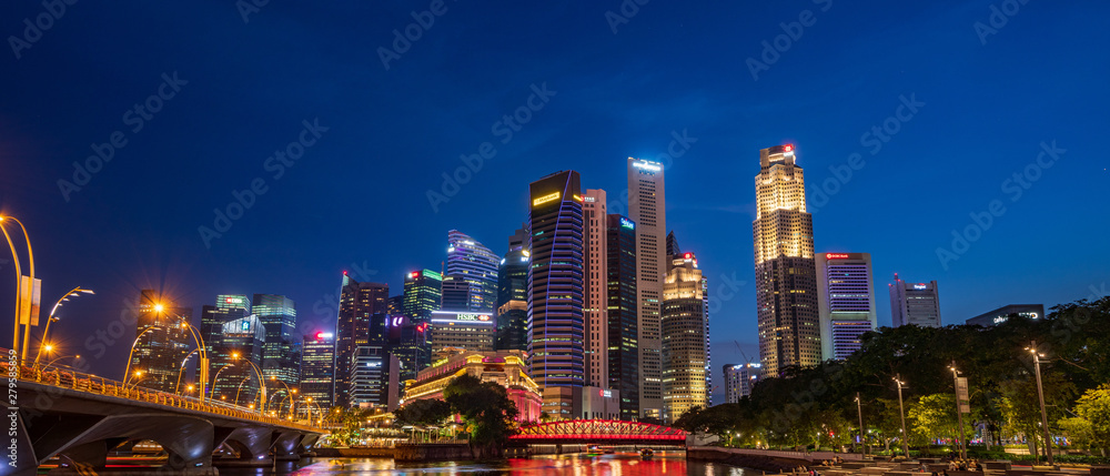 The Central Business District and Marina Bay skyline at dusk in Singapore