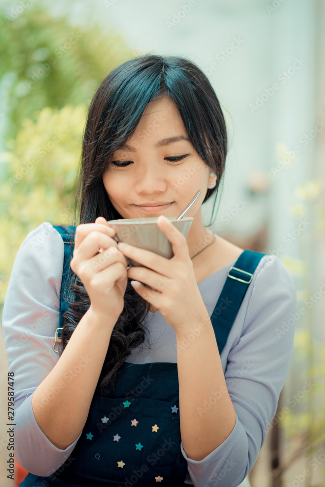 Beautiful asian women hold hot latte coffee