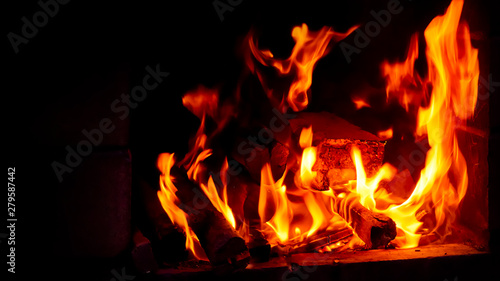 Wallpaper with a bright fire inside the brazier. Flame of fire. Preparation for cooking barbecue, kebabs. Hot coal with lights.