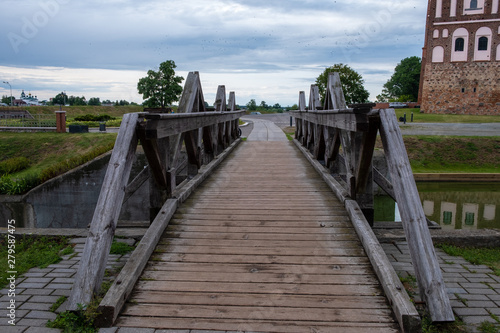 Photo of an ancient castle on nature in the summer by the river.