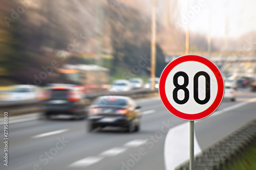Traffic sign showing speed limit on a highway full of cars photo