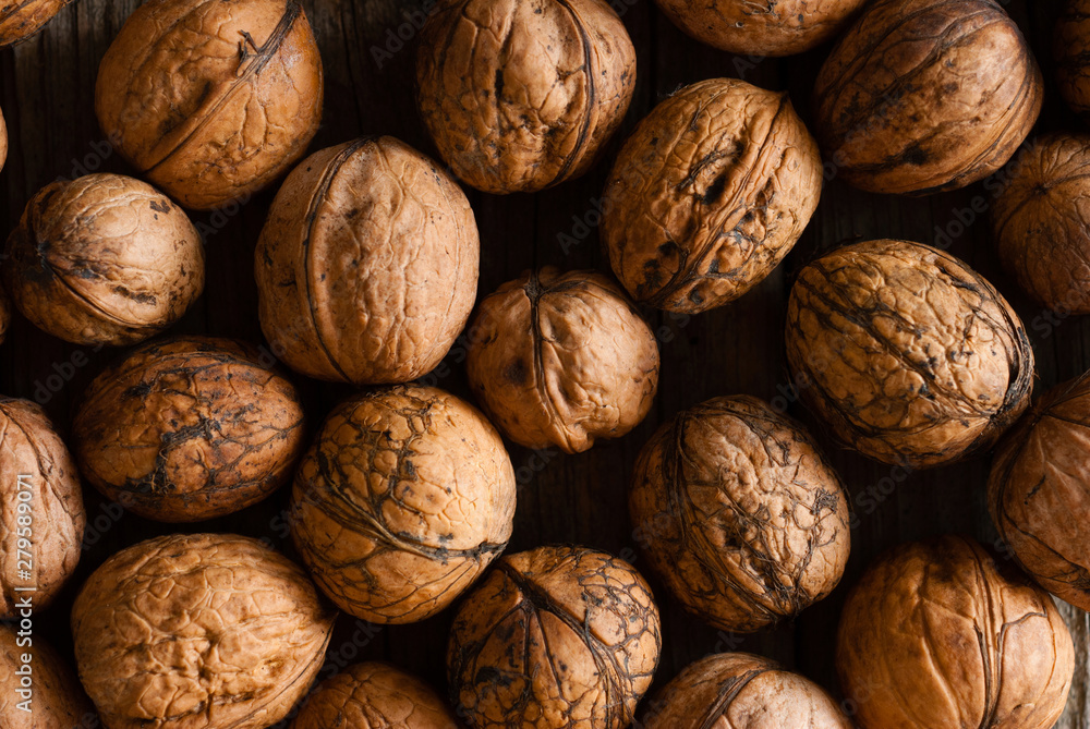 walnuts on old wooden table directly above walnuts on old wooden table directly above