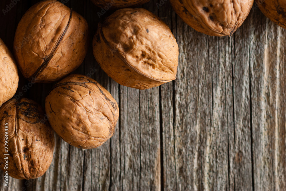 walnuts on old wooden table directly above walnuts on old wooden table directly above