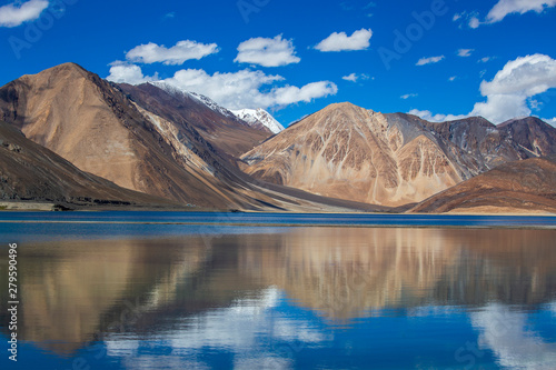 View of majestic rocky mountains against the blue sky and lake Pangong in Indian Himalayas, Ladakh region, India. Nature and travel concept